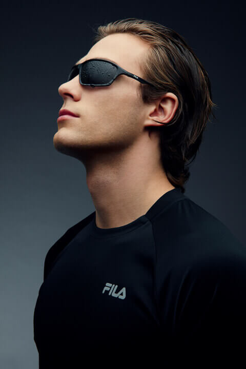 Man and woman in sport sunglasses with mirrored purple and orange polarized lenses.