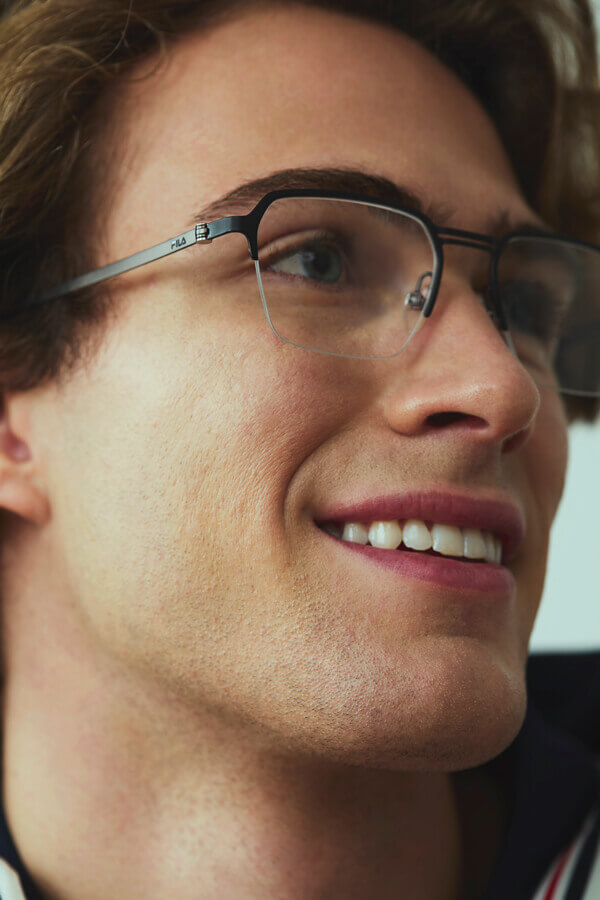 Man and woman holding a racket wearing Heritage collection eyeglasses.